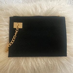 Black clutch with gold detail- never used- 1 side leather & the other faux fur